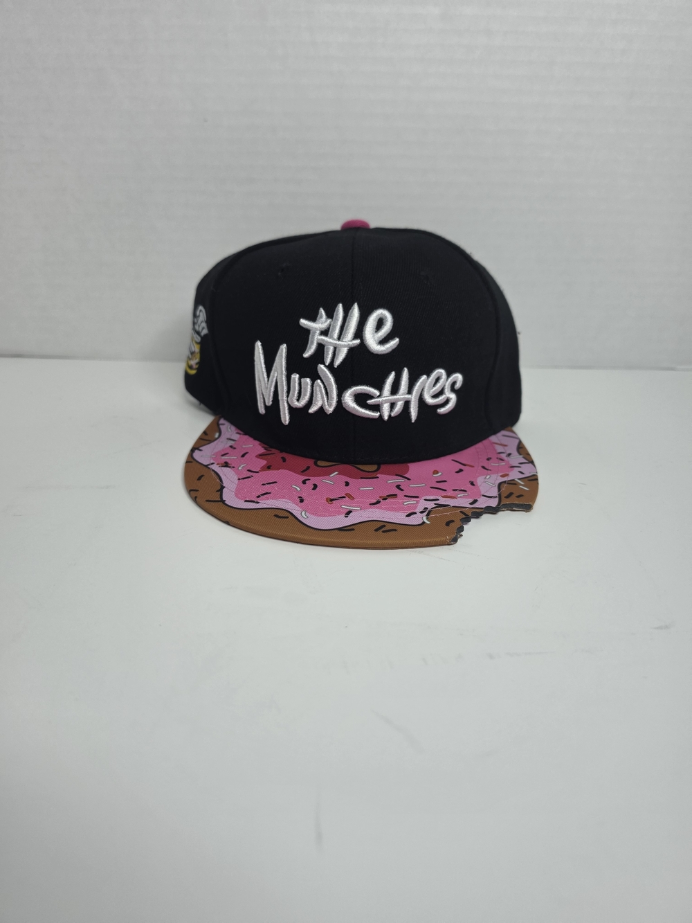 Black 'The Munchies' Snapback Hat with Pink Donut Brim